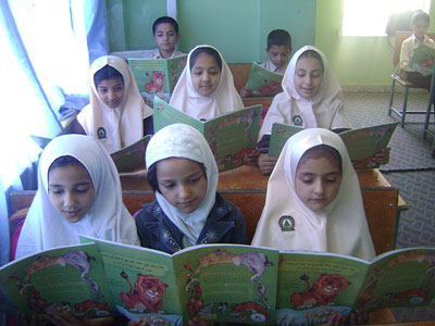 Afghan schoolgirls reading Hoopoe books in a classroom